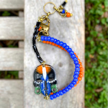 Load image into Gallery viewer, Black and Blue and Orange African Mask Wishbone Bracelet