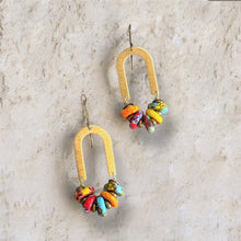 Load image into Gallery viewer, Colorful beaded earrings with gold hooks on a textured beige background