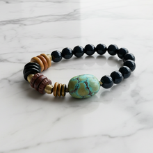 Load image into Gallery viewer, Beaded bracelet with a turquoise stone on a marble surface