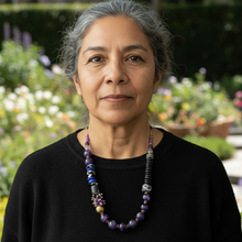 Load image into Gallery viewer, Woman wearing a black sweater and black and purple necklace in a garden setting