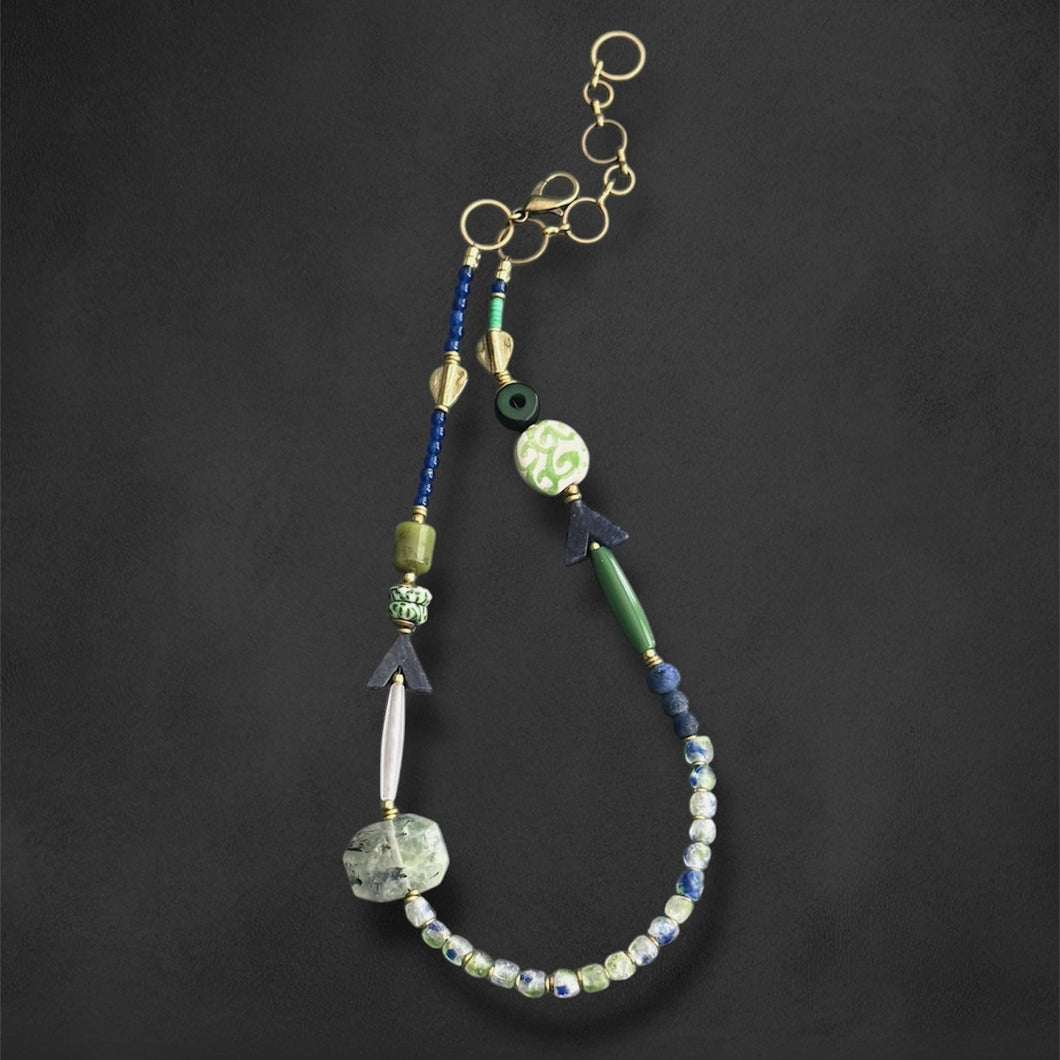 Beaded necklace with various beads on a dark background