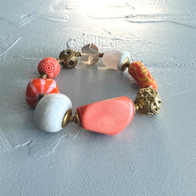 Load image into Gallery viewer, Pink and white beaded bracelet on a textured light grey  surface