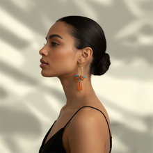 Load image into Gallery viewer, Woman wearing a pair of earrings with a blurred natural background