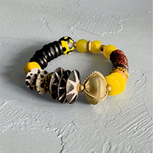 Load image into Gallery viewer, Yellow multicolored African beaded bracelet on a gray textured surface