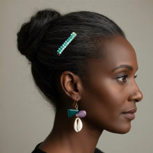 Load image into Gallery viewer, A woman in profile wearing an amazonite beaded hair clip and matching geometric dangle earrings, shown against a plain warm gray background.