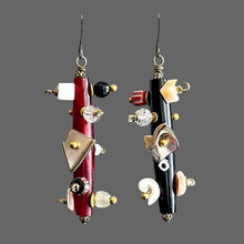 Load image into Gallery viewer, Pair of unique earrings with red, black, and gold elements on a gray background