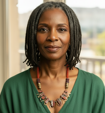 Load image into Gallery viewer, Woman wearing a green top and colorful necklace indoors with a blurred background