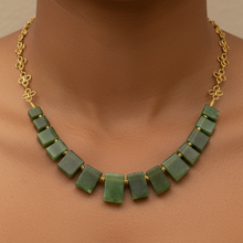 Load image into Gallery viewer, Green necklace with gold accents on a person's neck against a neutral background