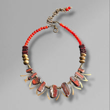 Load image into Gallery viewer, Necklace with rust, brown, orange and gold beads on a gray background