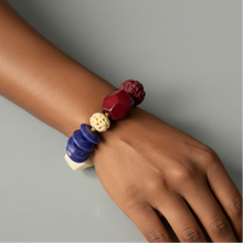 Load image into Gallery viewer, Multicolored beaded bracelet on a wrist against a gray background