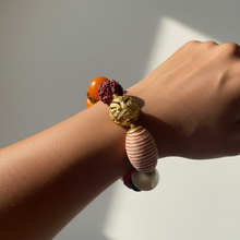 Load image into Gallery viewer, Bracelet with colorful beads on a wrist against a neutral background