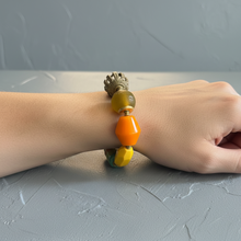 Load image into Gallery viewer, Citrus colored Bracelet with colorful beads on a wrist against a gray background