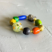 Load image into Gallery viewer, Colorful beaded bracelet on a textured light gray surface