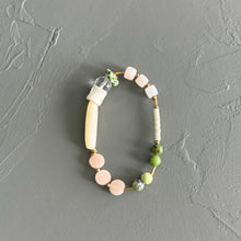 Load image into Gallery viewer, Beaded bracelet with pink, green, and white beads on a gray background