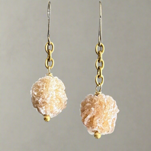 Load image into Gallery viewer, Pair of earrings with beige stone beads on gold hooks against a gray background
