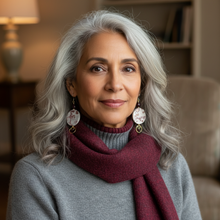 Load image into Gallery viewer, Woman with gray hair wearing a maroon scarf in a cozy indoor setting