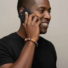 Load image into Gallery viewer, Man talking on a phone with a smile, wearing a black shirt and a bracelet.