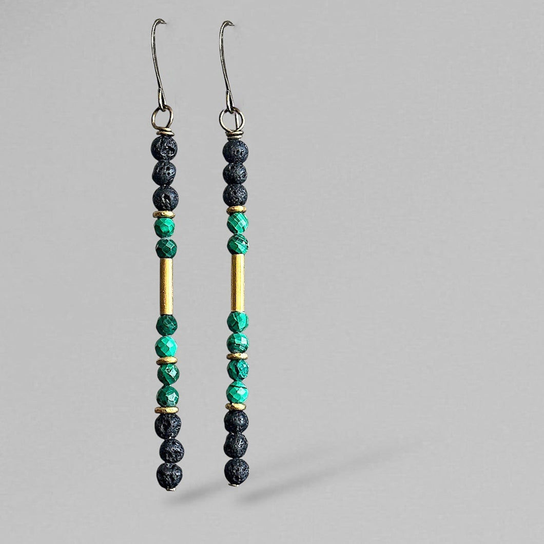 Pair of malachite matchstick beaded earrings on a gray background