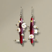 Load image into Gallery viewer, Pair of earrings with red and white beads on a beige background