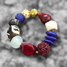 Load image into Gallery viewer, Multicolored beaded bracelet on a blurred natural background