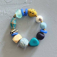 Load image into Gallery viewer, Colorful beaded bracelet on a textured gray surface