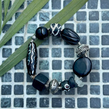 Load image into Gallery viewer, black and silver bracelet on a green grid background