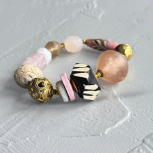 Load image into Gallery viewer, Pink and brown multicolored beaded bracelet on a textured white surface