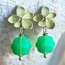 Load image into Gallery viewer, Gold flower-shaped earrings with green beads on a textured white background