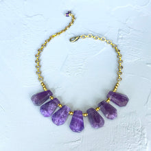 Load image into Gallery viewer, Necklace with purple beads and gold chain on a light gray background