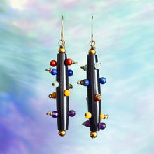 Load image into Gallery viewer, Colorful beaded earrings on a multicolored background