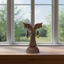Load image into Gallery viewer, Decorative wooden stand with earrings on a windowsill with a view of greenery outside.