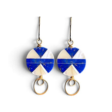 Load image into Gallery viewer, A pair of gold-tone dangle earrings with circular blue and white geometric charms and dangling oval gold rings, shown on a plain white background.