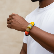 Load image into Gallery viewer, Person wearing a colorful beaded bracelet on a neutral background