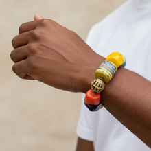 Load image into Gallery viewer, Colorful beaded bracelet on a wrist with a neutral background