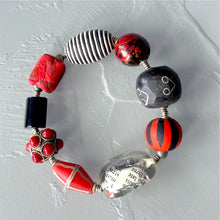 Load image into Gallery viewer, Colorful beaded bracelet with red, black, and silver beads on a light gray background