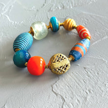 Load image into Gallery viewer, Colorful teal and orange beaded bracelet with a gold accent on a light gray background