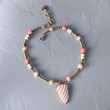 Load image into Gallery viewer, Necklace with pink and white stone pendant on a gray surface