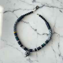 Load image into Gallery viewer, Necklace with black and silver beads on a marble surface