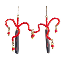 Load image into Gallery viewer, Pair of earrings with red beaded loops and black cylindrical charms on a white background