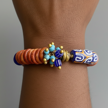Load image into Gallery viewer, Colorful blue beaded bracelet on a wrist against a neutral background