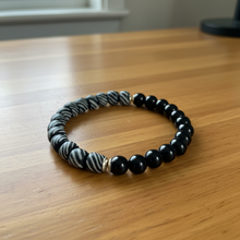 Load image into Gallery viewer, Black and white beaded bracelet on a wooden surface