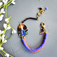 Load image into Gallery viewer, Black and Blue and Orange African Mask Wishbone Bracelet